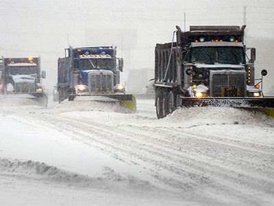 trucks plowing snow