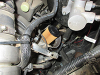 new oil filter being installed in housing