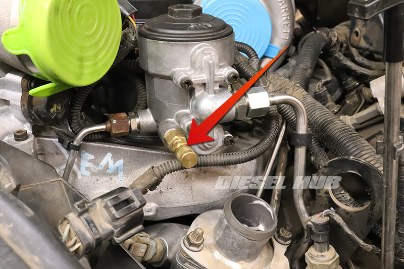Fuel pressure test fitting installed at the secondary fuel filter housing