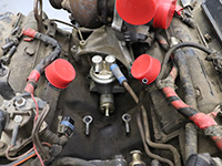 fuel bowl removed from engine exposing fuel pump