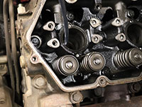 extracting fluid from combustion chamber after removing the sleeve