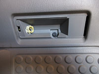 Removing lower door panel screw